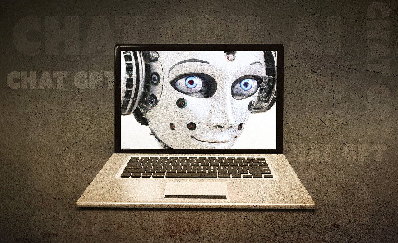 Laptop med bild på robotliknande ansikte och texten chat gpt och AI i bakgrunden.